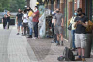 Young people queue outside Greenwich pharmacy to get vaccinated.