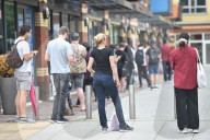 Young people queue outside Greenwich pharmacy to get vaccinated.