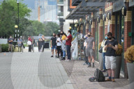 Young people queue outside Greenwich pharmacy to get vaccinated.