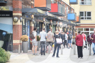 Young people queue outside Greenwich pharmacy to get vaccinated.