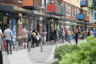 Young people queue outside Greenwich pharmacy to get vaccinated.