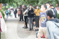 Young people queue outside Greenwich pharmacy to get vaccinated.