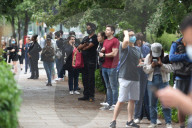 Young people queue outside Greenwich pharmacy to get vaccinated.