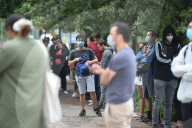 Young people queue outside Greenwich pharmacy to get vaccinated.