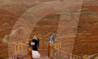 FEATURE -  Touristen in den Rainbow Mountains in Wangye, China