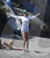 A makeup free Minnie Driver, 51,  seen spending time with friends sunbathing and swimming on the beach in Malibu. 