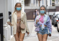 Members of the public wear masks in London today.