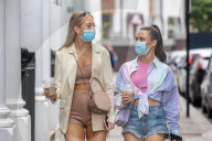 Members of the public wear masks in London today.
