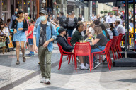 Members of the public wear masks in London today.