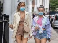 Members of the public wear masks in London today.