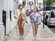 Members of the public wear masks in London today.