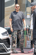 Scott Disick shows off a new buzz cut and yet another fancy new sports car to add to his growing collection of luxury automobiles. 