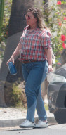 A stony faced Kelly Clarkson puts her divorce and custody drama aside as she heads to an afternoon meeting holding a coffee mug which carried the logo of her popular TV talk show. 