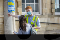 Members of the public queue outside a temporary Covid-19 vaccine centre at Battersea Arts Centre.