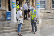 Members of the public queue outside a temporary Covid-19 vaccine centre at Battersea Arts Centre.