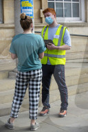 Members of the public queue outside a temporary Covid-19 vaccine centre at Battersea Arts Centre.