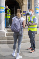 Members of the public queue outside a temporary Covid-19 vaccine centre at Battersea Arts Centre.