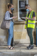 Members of the public queue outside a temporary Covid-19 vaccine centre at Battersea Arts Centre.
