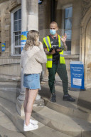 Members of the public queue outside a temporary Covid-19 vaccine centre at Battersea Arts Centre.