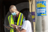 Members of the public queue outside a temporary Covid-19 vaccine centre at Battersea Arts Centre.