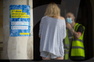 Members of the public queue outside a temporary Covid-19 vaccine centre at Battersea Arts Centre.