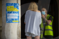 Members of the public queue outside a temporary Covid-19 vaccine centre at Battersea Arts Centre.