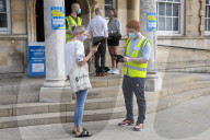 Members of the public queue outside a temporary Covid-19 vaccine centre at Battersea Arts Centre.
