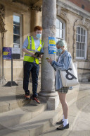 Members of the public queue outside a temporary Covid-19 vaccine centre at Battersea Arts Centre.