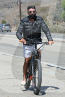 Simon Cowell takes his electric bike for a spin around Malibu without a helmet as he is seen in LA for the first time since returning from his summer vacation in Barbados.