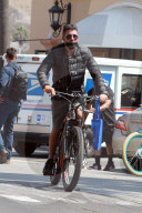 Simon Cowell, 61, and his long term partner Lauren Silverman, 44, enjoy a heathy family bike ride in their Malibu neighborhood with son Eric, 7. 