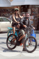 Simon Cowell, 61, and his long term partner Lauren Silverman, 44, enjoy a heathy family bike ride in their Malibu neighborhood with son Eric, 7. 