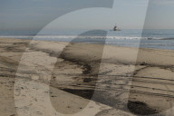 Huntington Beach oil spill blackens beaches and waves.
