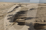 Huntington Beach oil spill blackens beaches and waves.