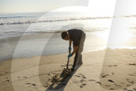 Huntington Beach oil spill blackens beaches and waves.