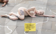 Protestors lie ‘dead’ in meat industry ‘crime scene’ on world vegan day, Piccadilly Circus, London, UK.