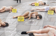 Protestors lie ‘dead’ in meat industry ‘crime scene’ on world vegan day, Piccadilly Circus, London, UK.