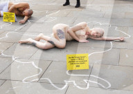 Protestors lie ‘dead’ in meat industry ‘crime scene’ on world vegan day, Piccadilly Circus, London, UK.