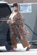 A dressed down Melissa McCarthy pumps gas whole running errands early on Saturday morning in the San Fernando Valley.