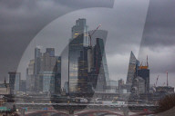 Christmas shoppers struggle in the wind on Waterloo Bridge, London