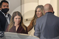 Jennifer Aniston, 52, puts her sensational figure on display as she arrives at The Hollywood ReporterÍs annual Women in Entertainment holding what appears to be her acceptance speech. 