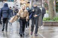 Members of the public brave the rain while shopping London.