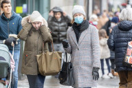 Members of the public brave the rain while shopping London.