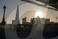 Commuters at sunrise on a cold day in London, UK.