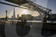 Commuters at sunrise on a cold day in London, UK.
