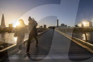 Commuters at sunrise on a cold day in London, UK.