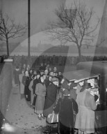 Still they come to pay homage ÖÖ
These queuers found a hot drink a welcome respite when it was supplied from a mobile canteen by members of the WVS ñ they had been lining up for many hours to pay their last respects to King George VI who is lying-in-sta