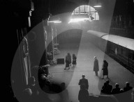 King George VI 's  coffin arrives in London.  The two Queens and Princess follow the cortege out of the station.  Photo shows:  The new Queen , Elizabeth II , the Queen Mother and Princess Margaret, leaving the platform at King's Cross Station. London , a