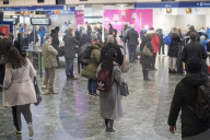Passengers waiting at Euston station this morning.
