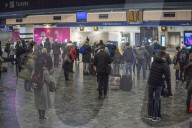 Passengers waiting at Euston station this morning.