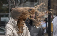 Commuters are blown about by Storm Franklin in London UK